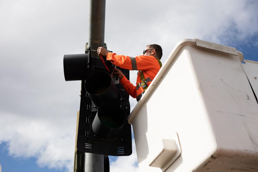 Man fixing signal light